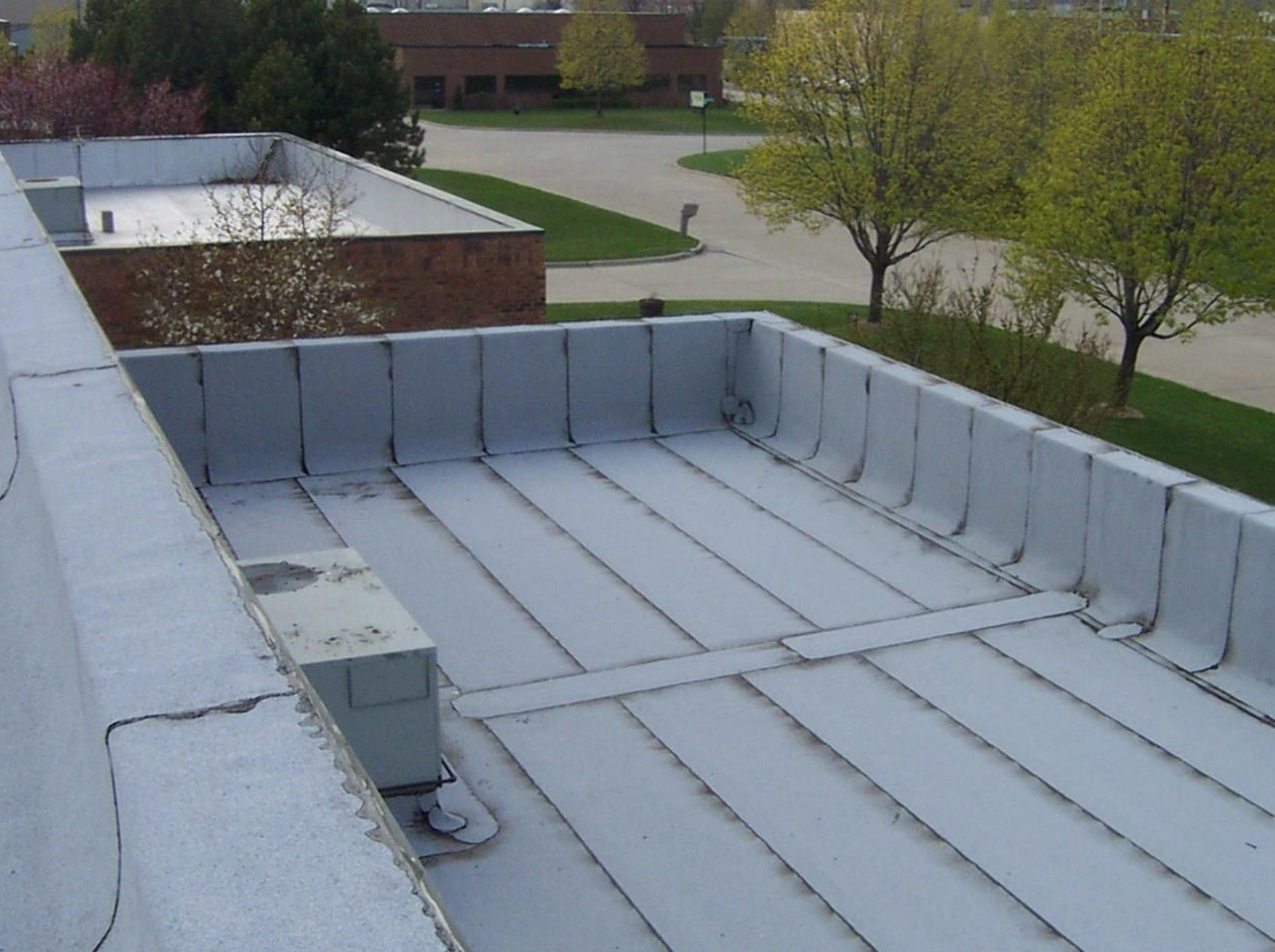 rubber roofing system in gray, covering the roof of a spacious office building.